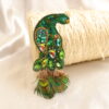 Prendedor en forma de pavo real